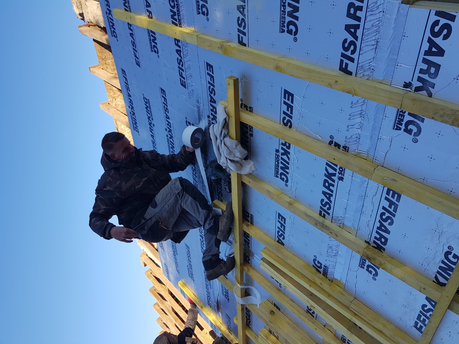 Pose de panneaux Efisarking Soprema lors d’une isolation de toiture par sarking.